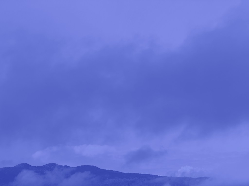 Image showing an blue-colored cloud against a sky.